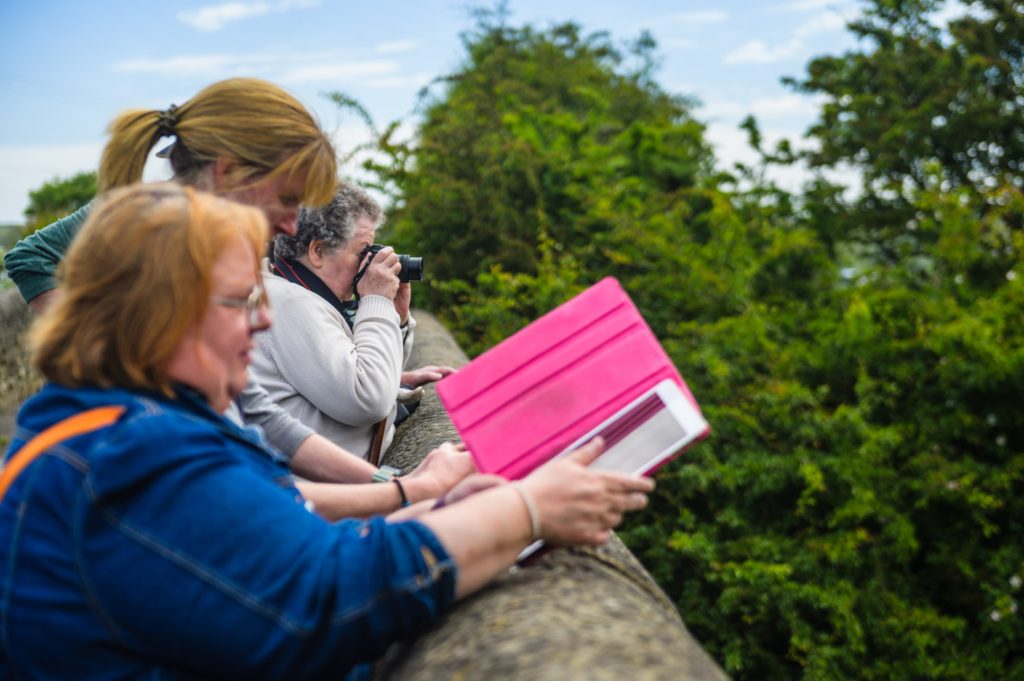 Photograph of a group of people creating images on cameras and Ipads