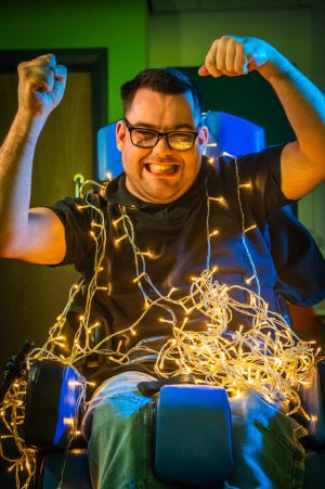 Photograph of happy young man, using a wheelchair.